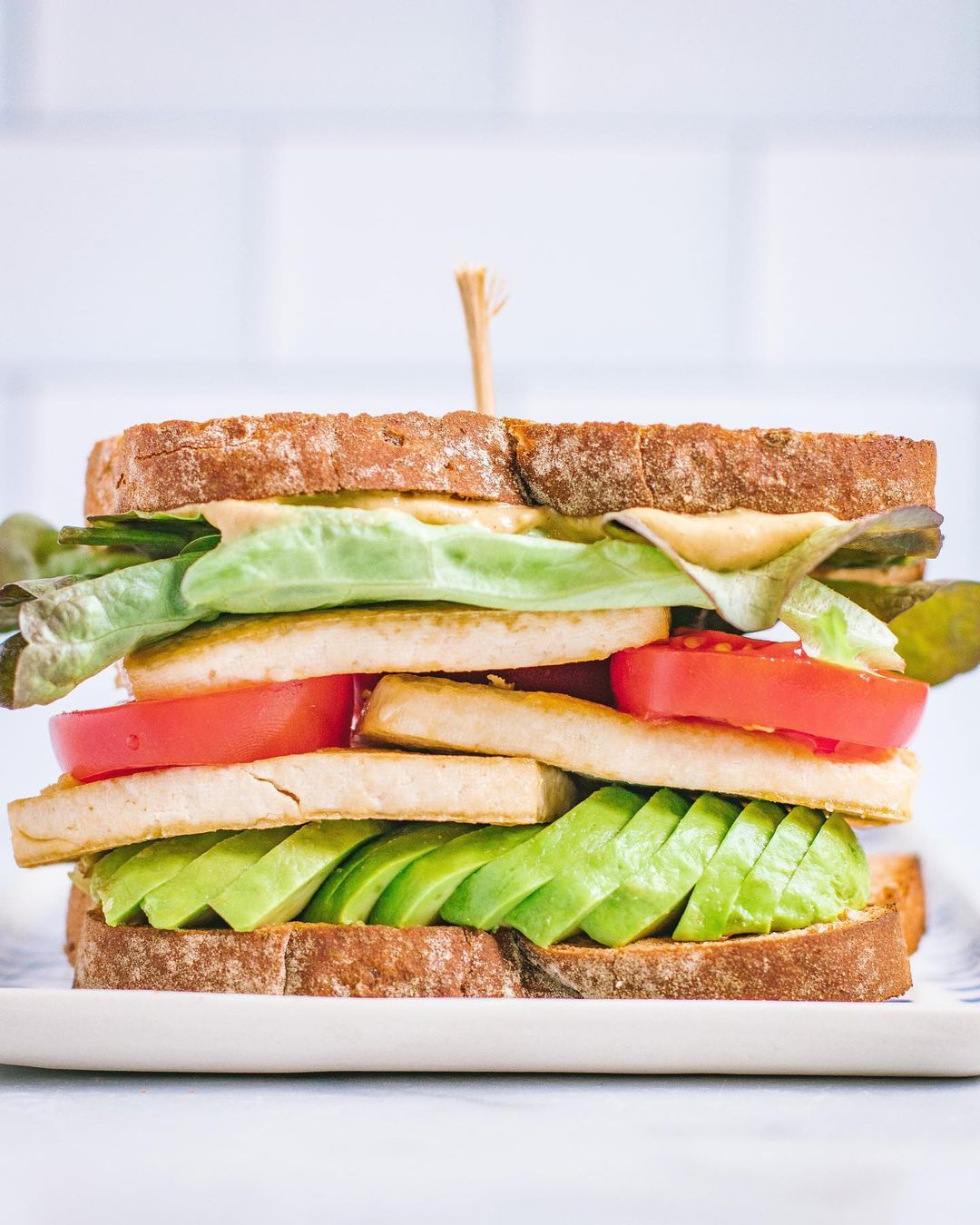 Stacked and Loaded Tofu Avocado Lettuce Tomato Sandwich