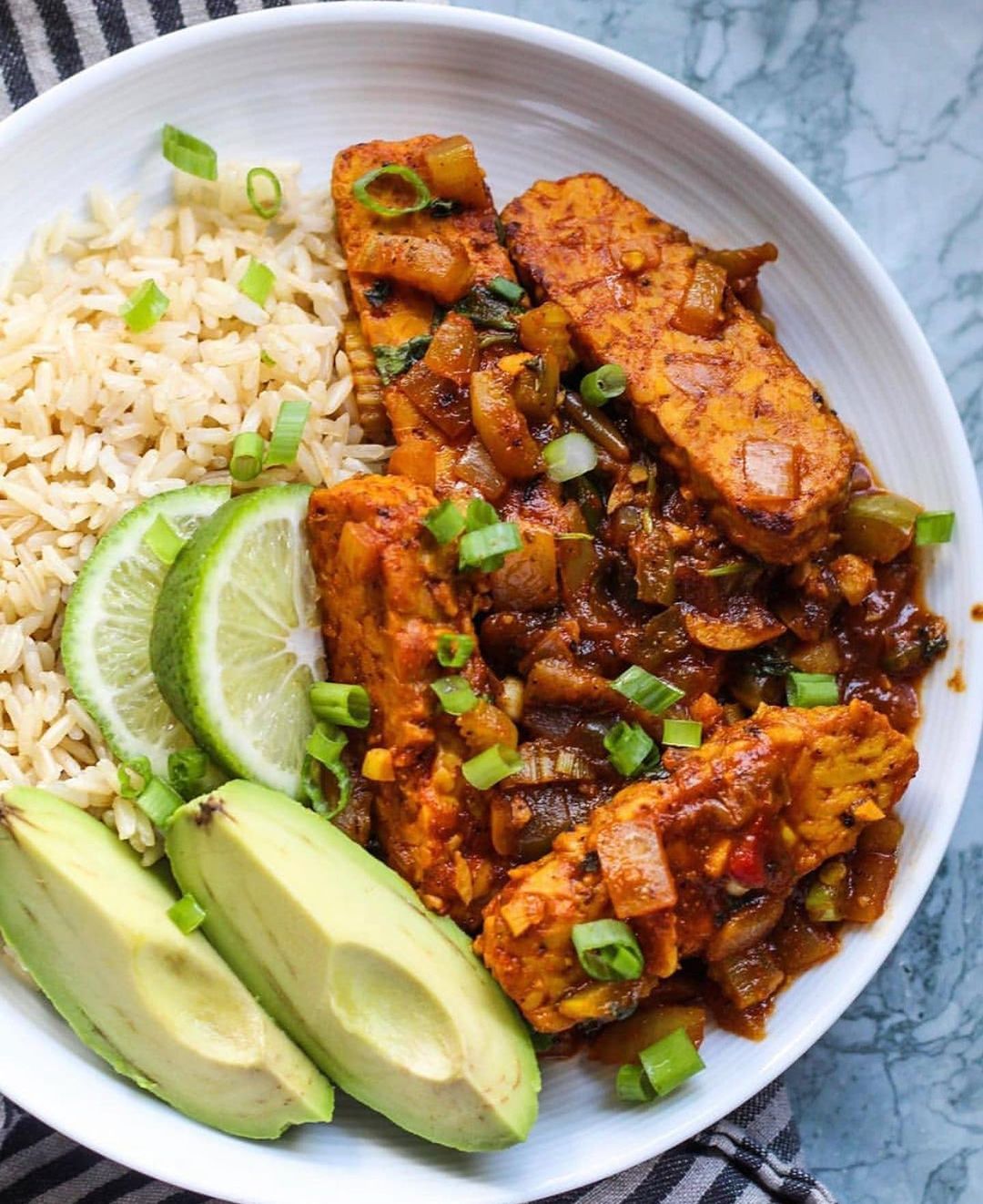 Tasty Tempeh Guisado Served with Rice and Avocado