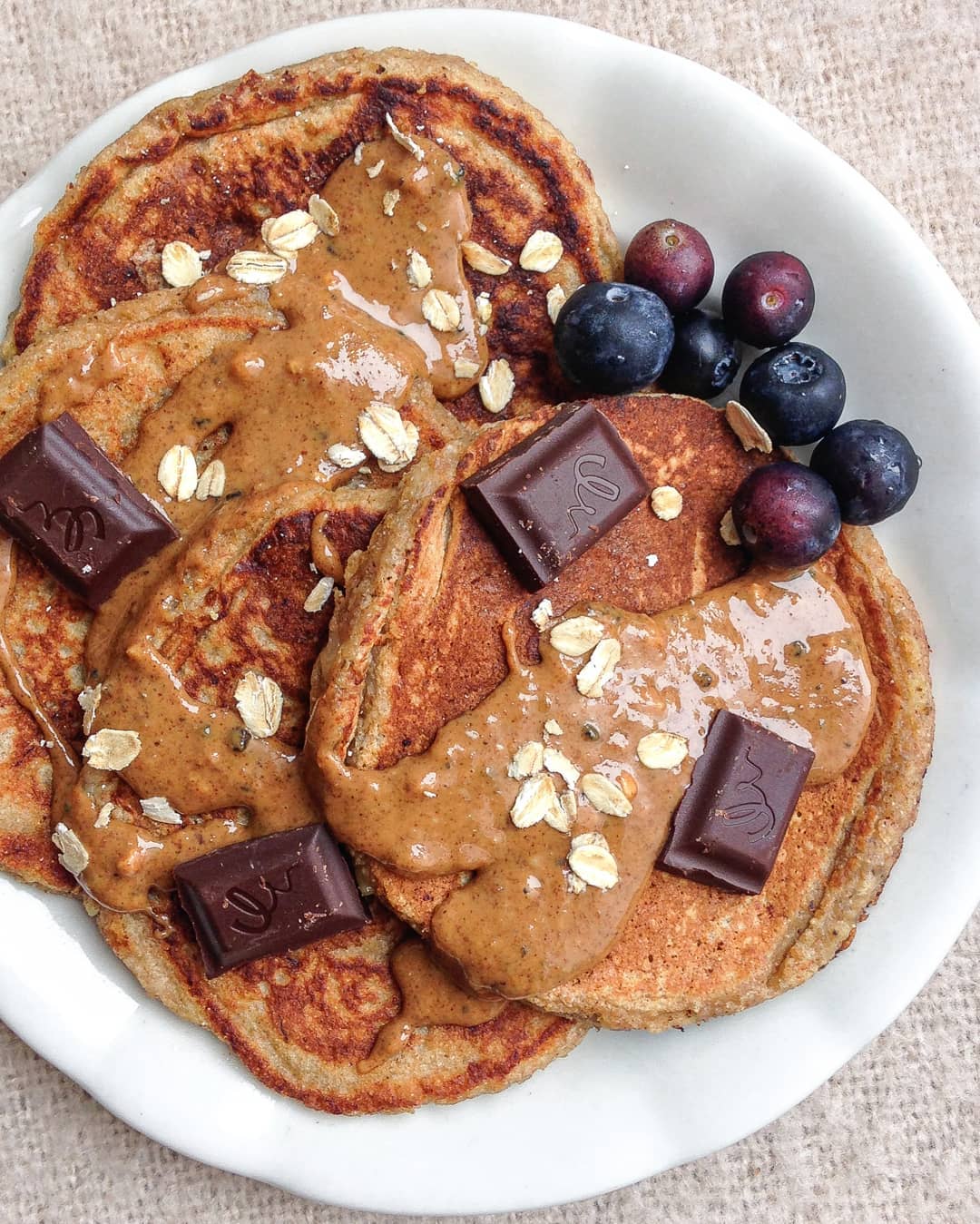 Banana Bread Pancakes with Chocolate, Almond Butter, and Blueberries