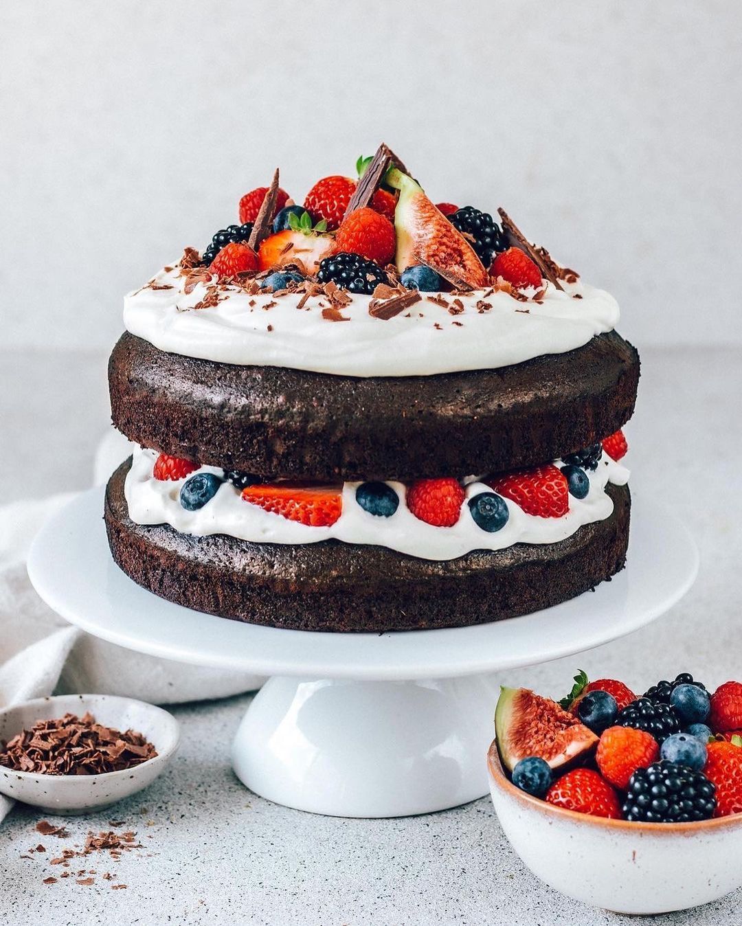 Layered Vegan Chocolate Cake with Whipped Cream and Fresh Berries