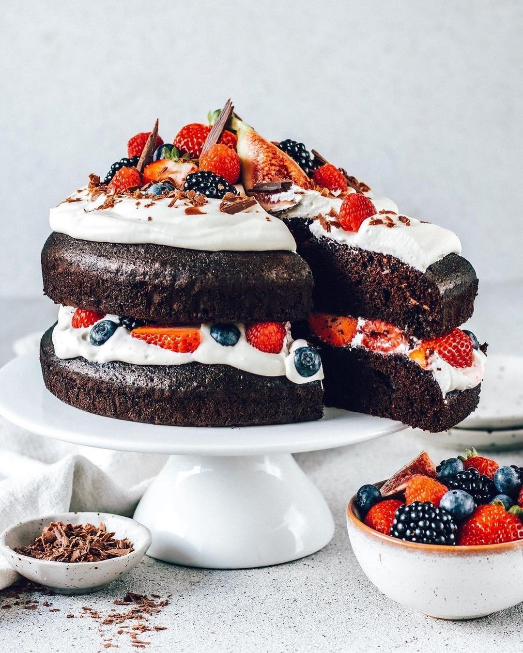 Layered Vegan Chocolate Cake with Whipped Cream and Fresh Berries