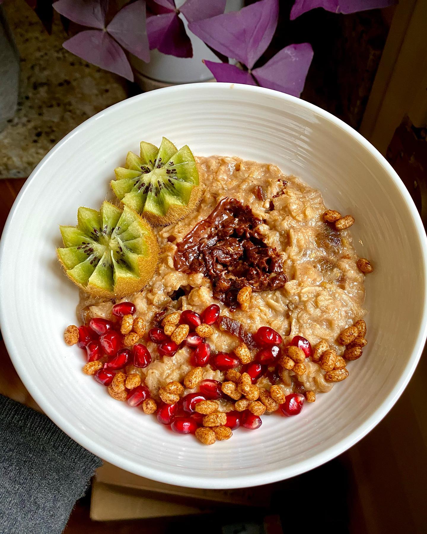 Nutty Spiced Oatmeal Bowl with Kiwi Flowers and Dark Chocolate Drizzle