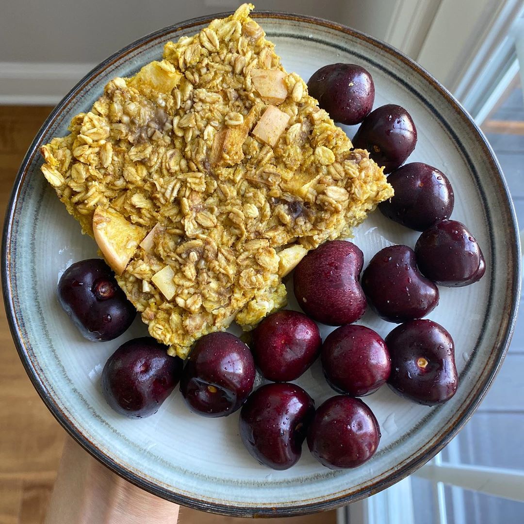 Slice of Apple Turmeric Spice Oat Bake with a Side of Cherries