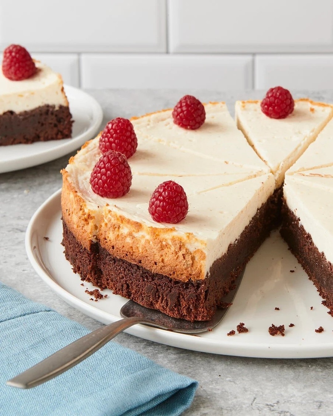 Layered Brownie Cheesecake with Fresh Raspberries