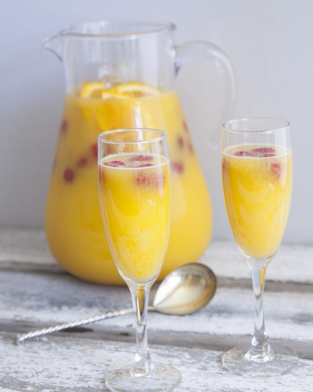 Ginger Kombucha Mimosa with Orange Juice and Raspberries