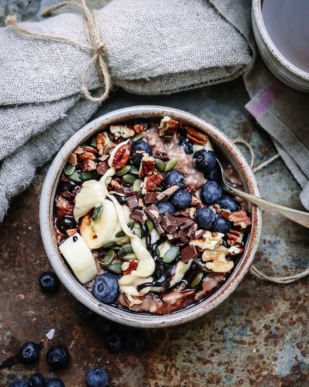 Hot Cacao Banana Porridge with Nuts and Berries