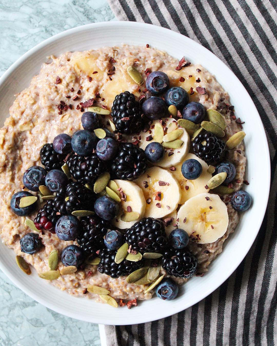 Warm Oatmeal Bowl with Bananas and Berries