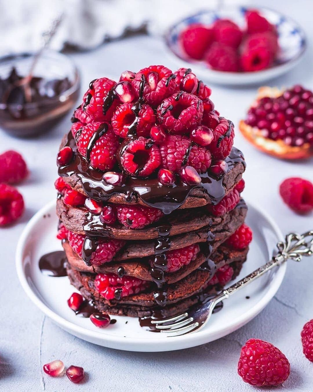 Chocolate Protein Pancakes with Raspberries and Pomegranate Seeds