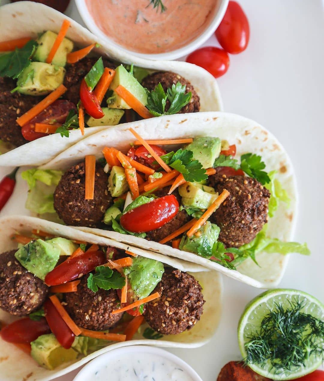 These Tacos Have Falafel, Lettuce, Avocado Salsa with Vegan Tzatziki and Spicy Mayo