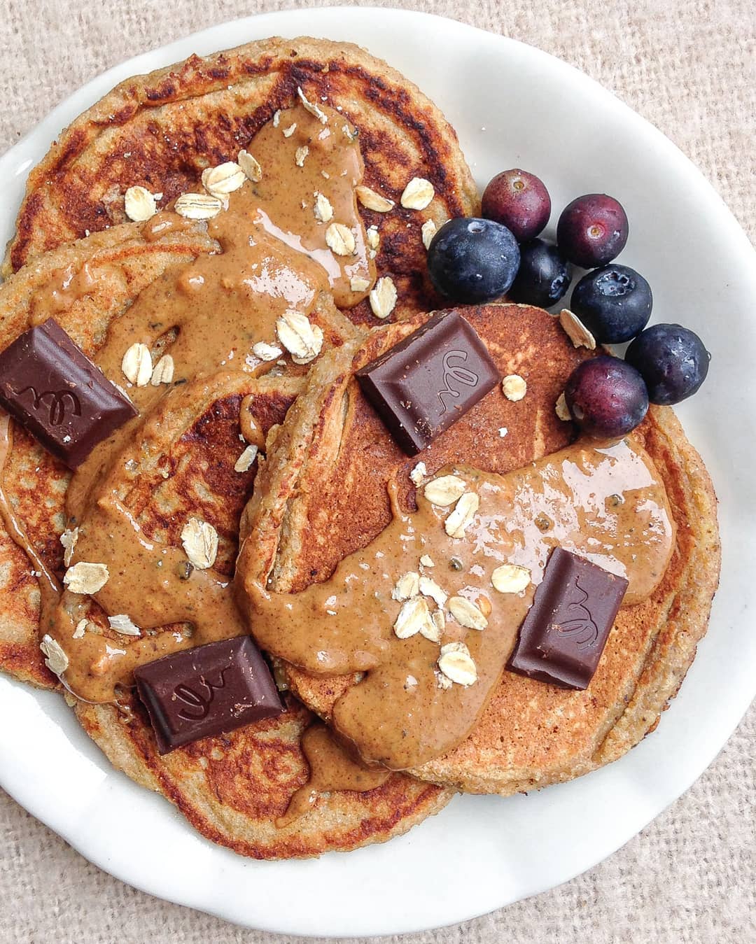 Banana Bread Pancakes with Chocolate, Almond Butter, and Blueberries